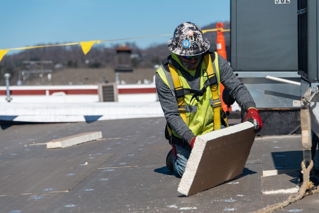 Benton Roofing: roofer installing insulation